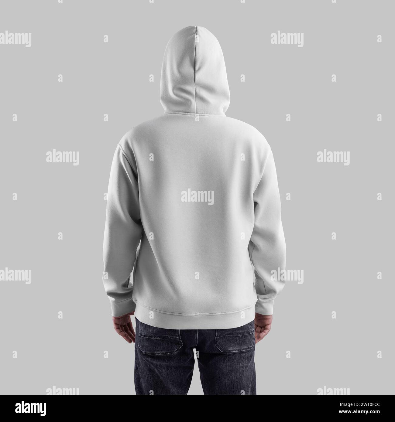 Template white hoodie oversize on a man in a hood, in dark jeans, back view. Male sweatshirt mockup isolated on background. Fashionable clothing with Stock Photo