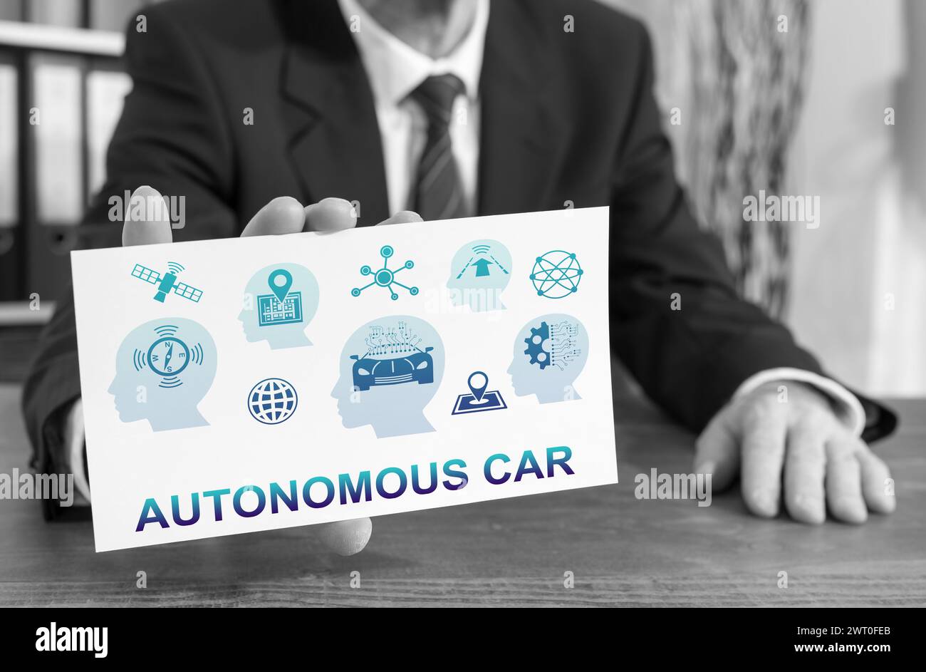 Businessman showing an index card with autonomous car concept Stock Photo