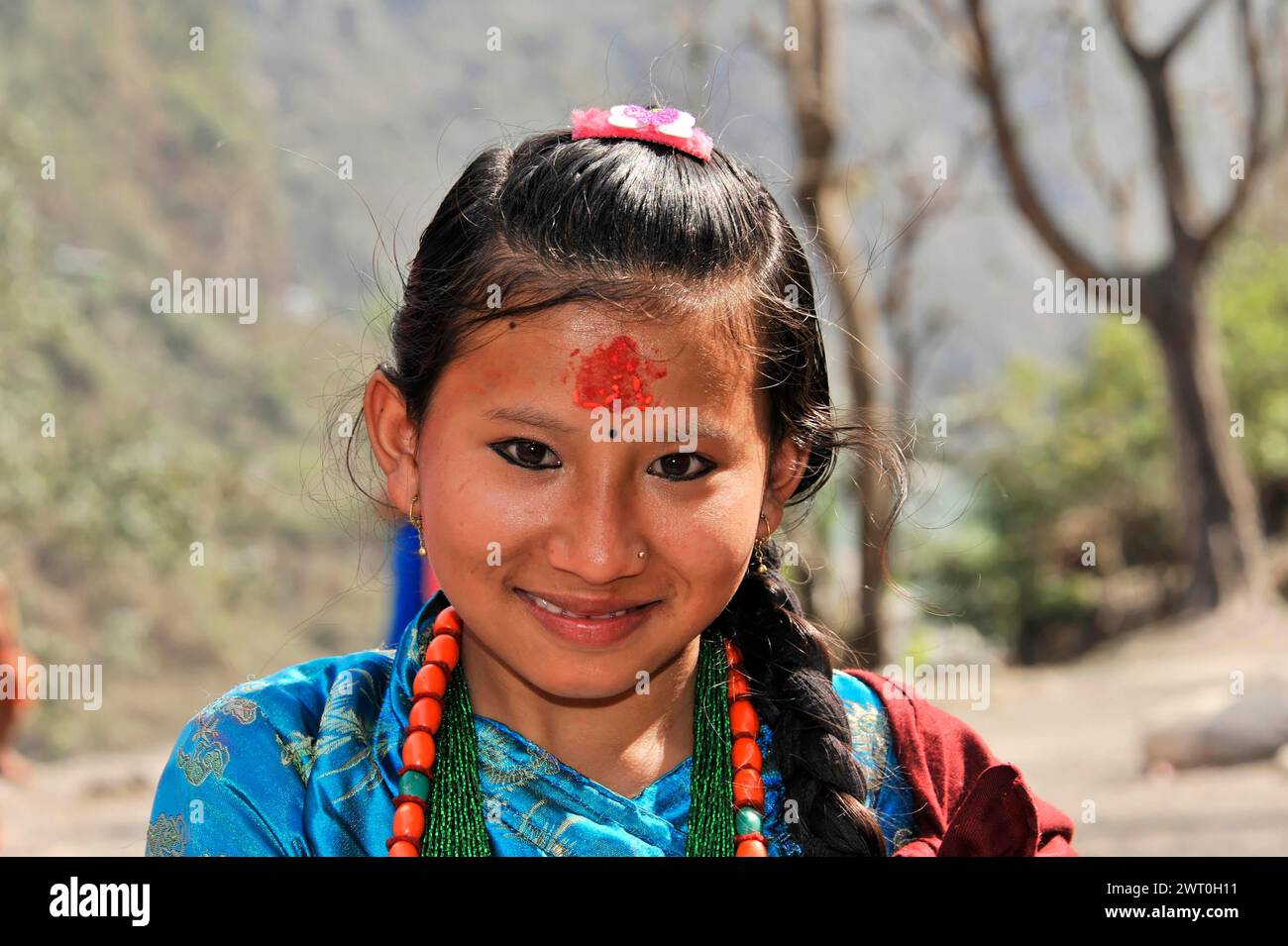Portrait of a smiling young girl in traditional dress, Bhairahawa, Pokhara, Nepal Stock Photo