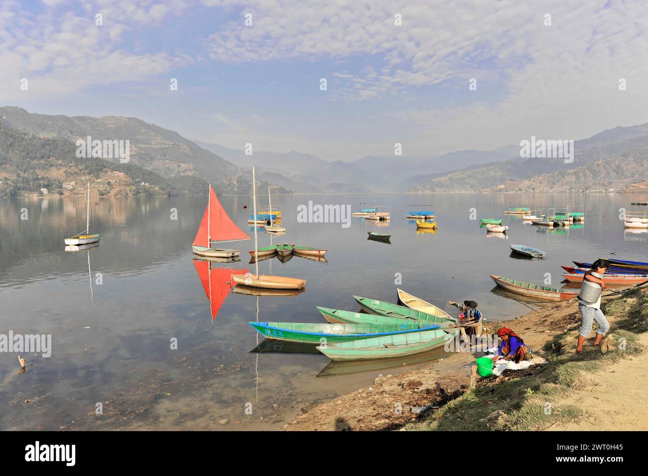 People doing various activities near the lake, Lake Pehwa with boats ...