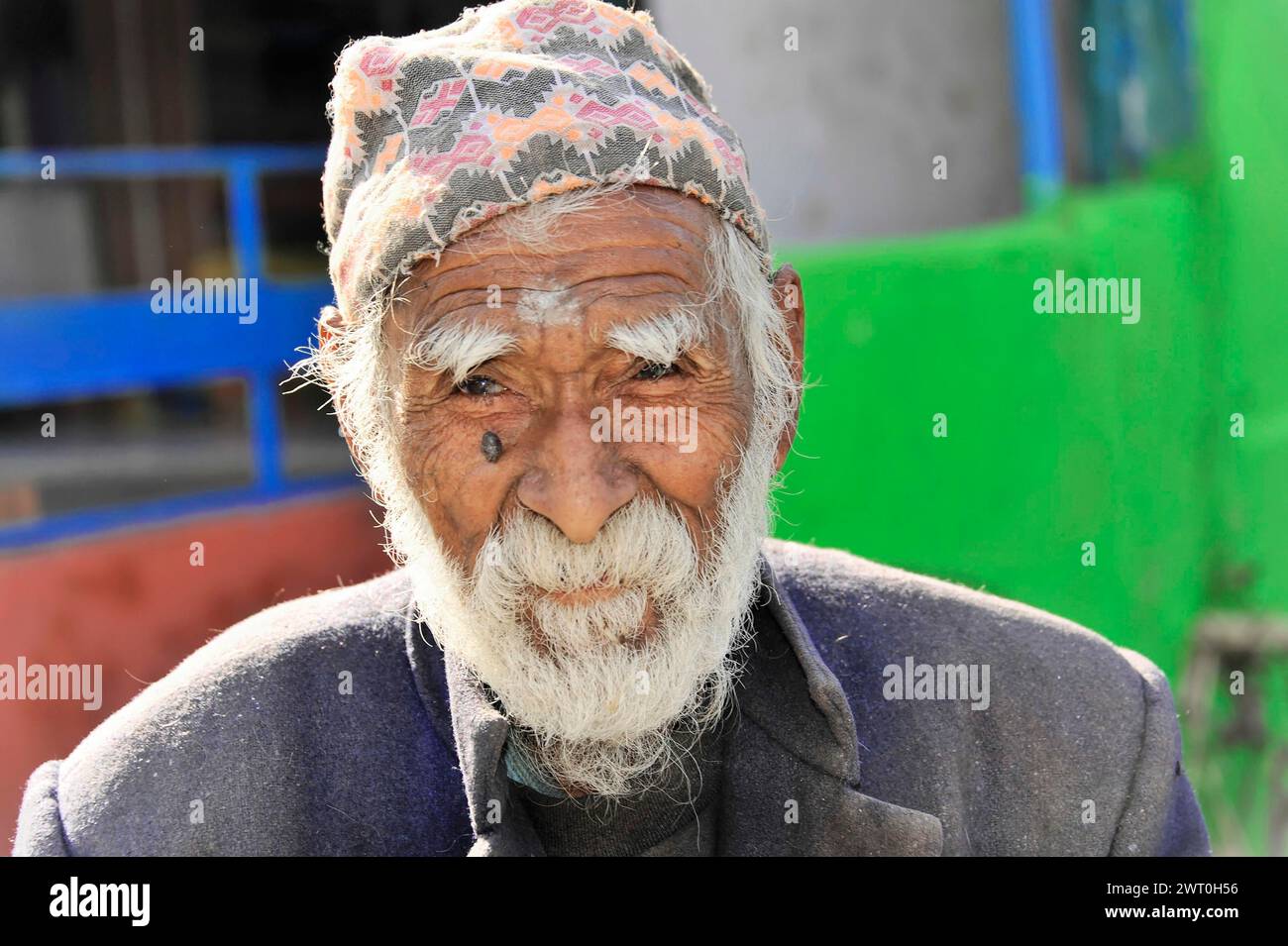 An aged man with a cap shows a striking face full of character, Pokhara Valley, Pokhara, Nepal Stock Photo