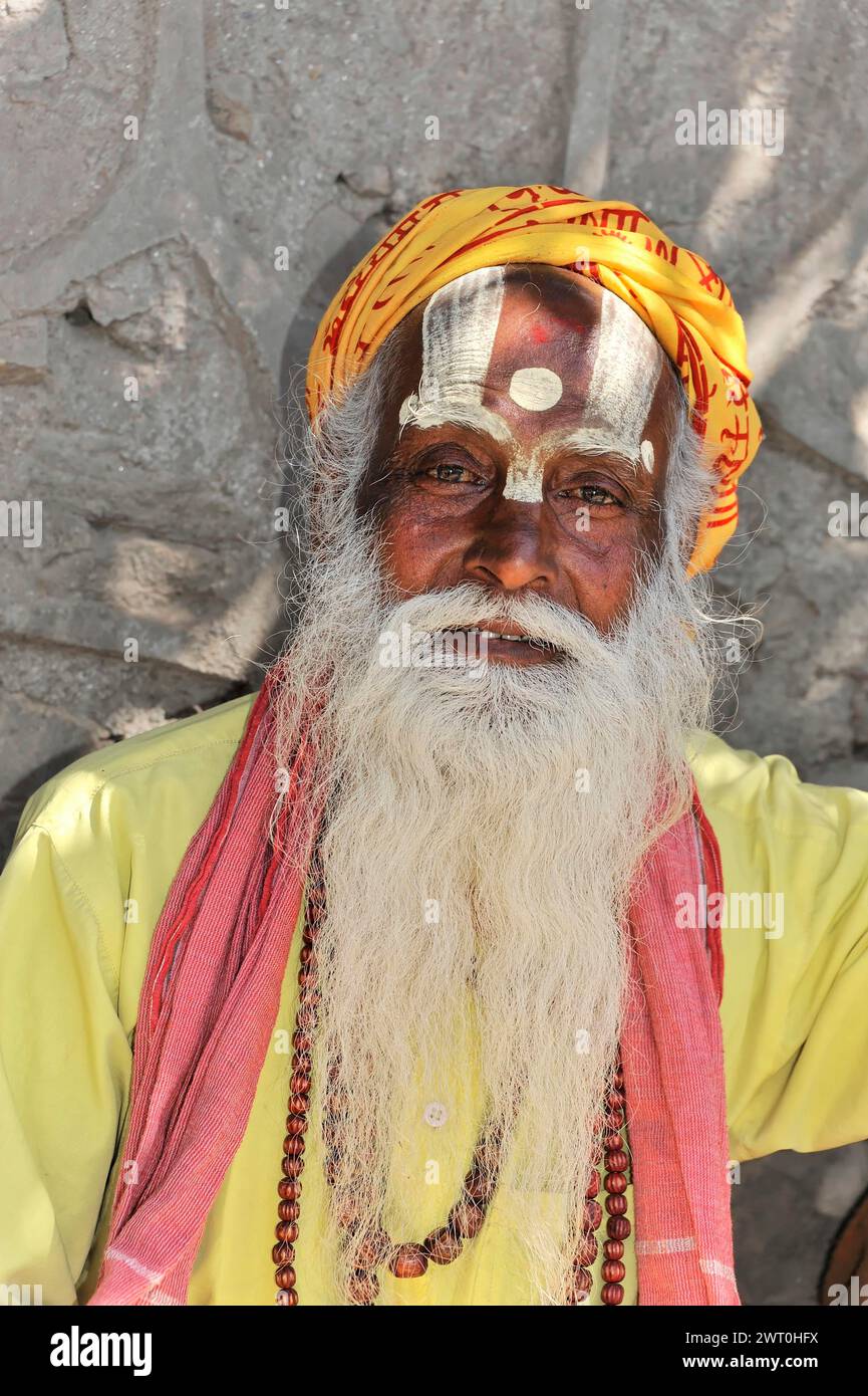 Portrait of an elderly man in traditional dress with yellow turban and ...