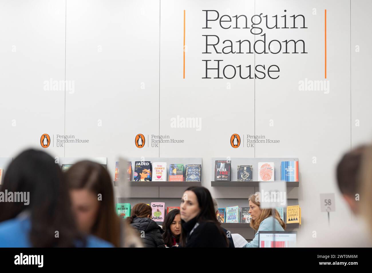 Meetings and book deals on the Penguin Random House book trade stand during the third and final day of the London Book Fair at the Olympia Exhibition Hall, on 14th March 2024, in London, England. The three-day international London Book Fair (LBF) is an annual publishing industry expo and Europe's largest spring book fair that typically attracts 25,000 visitors; exhibitors from across the publishing sector; authors hoping for their book ideas to be commissioned and where international publication rights deals are made for foreign editions. Stock Photo