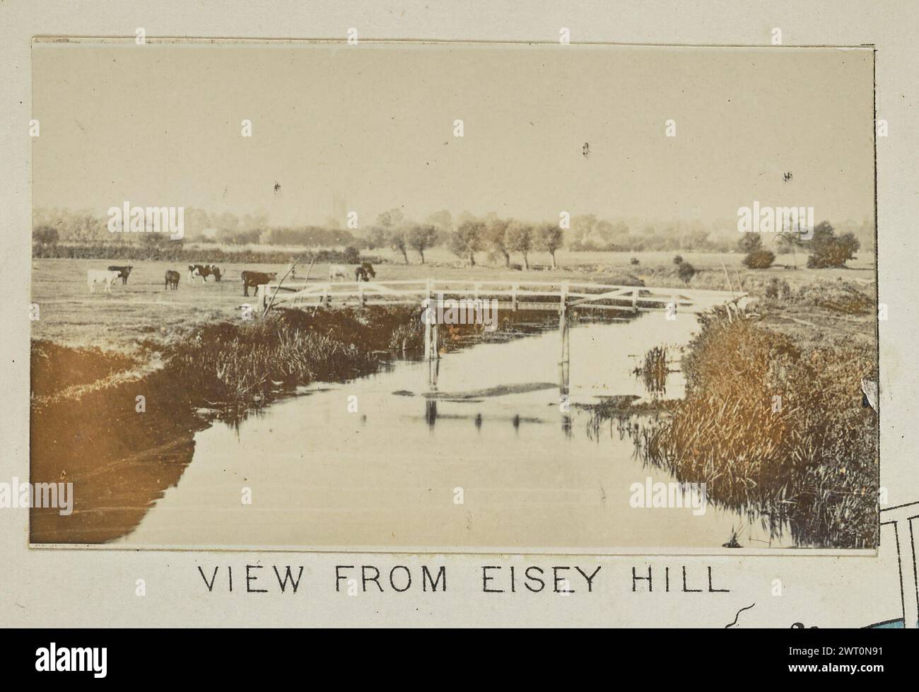 View from Eisey Hill. Henry W. Taunt, photographer (British, 1842 - 1922) 1897 One of three tipped-in photographs illustrating a printed map of Castle Eaton, Kempsford, and the surrounding area along the River Thames. The photograph shows a view of a wooden footbridge over a narrow stretch of the river near Cricklade. Cows graze in the field beside the river on the left side of the image. (Recto, mount) lower center, below image, printed in black ink: 'VIEW FROM EISEY HILL' Stock Photo