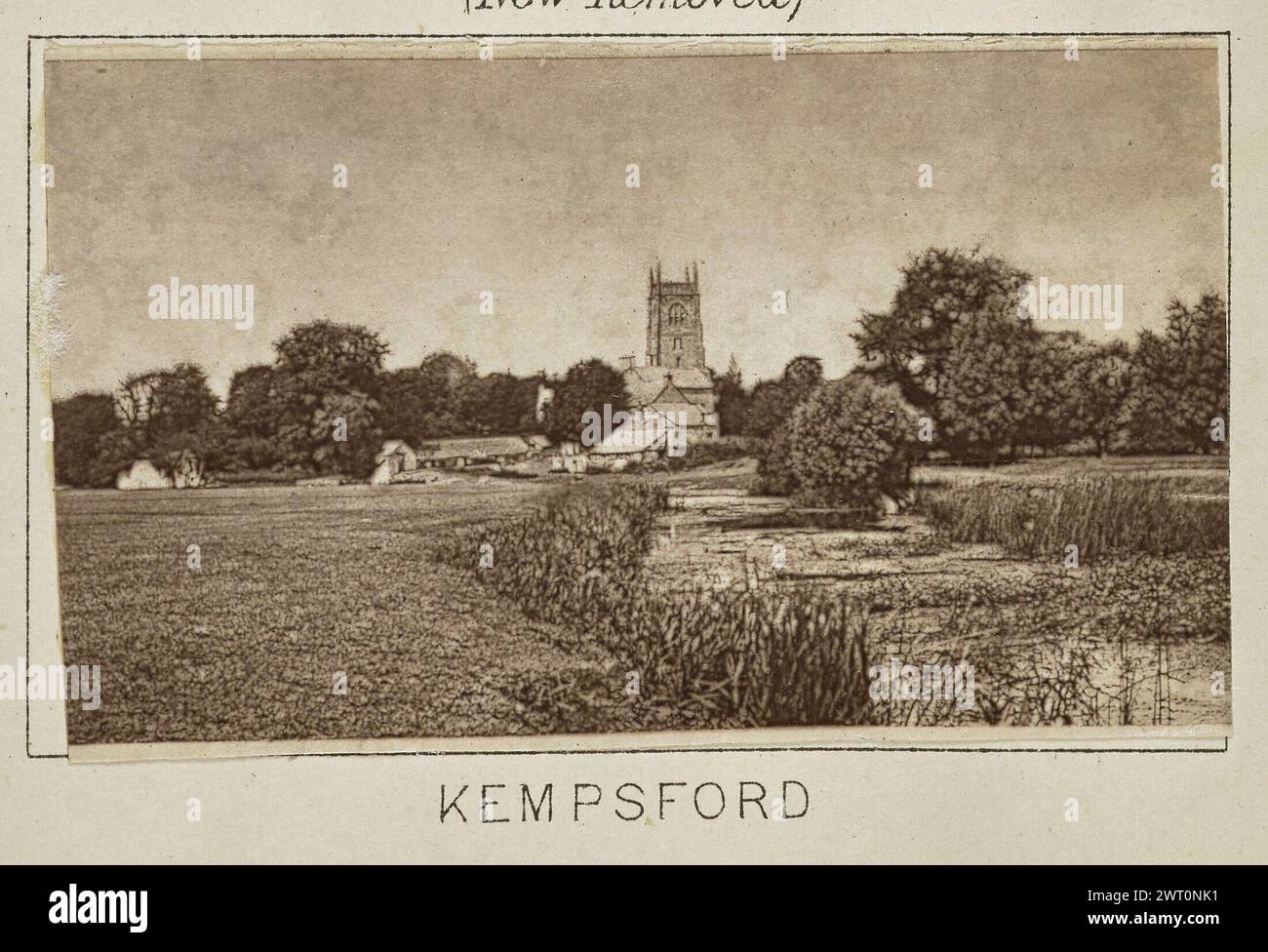 Kempsford. Henry W. Taunt, photographer (British, 1842 - 1922) about 1886 One of three tipped-in photographs illustrating a printed map of Castle Eaton, Kempsford, and the surrounding area along the River Thames. The photograph shows a view of the river at Kempsford with St. Mary's Church and the surrounding buildings visible across a field in the distance. (Recto, mount) lower center, below image, printed in black ink: 'KEMPSFORD' Stock Photo