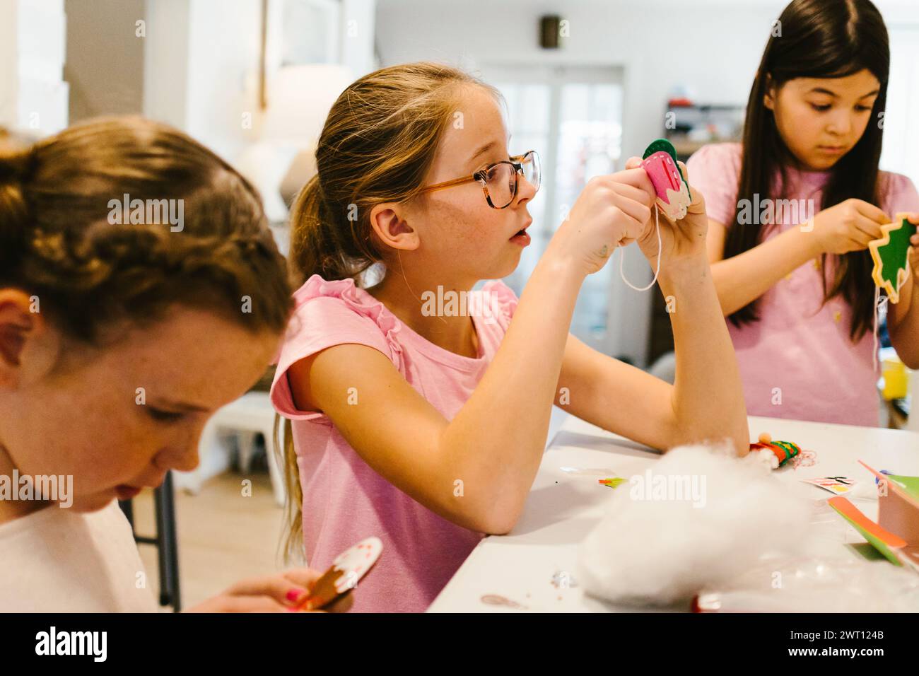 Girl multiracial child cousins work together on craft project Stock Photo