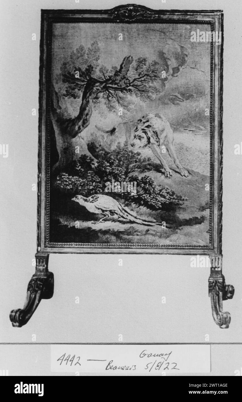 Dog on the watch for pheasant. Oudry, Jean-Baptiste (French, 1686-1755) (author of design) [painter] c. 1735-1770 Tapestry Dimensions: H 0.92 x W 0.55 m Tapestry Materials/Techniques: unknown Culture: French Weaving Center: Beauvais Ownership History: Mme. la Marquise de Ganay coll., born Ridgway. Galerie Georges Petit, 5/8-10/1922, Paris, lot 253. Hound dog looking closely in the direction of a bush, under which a pheasant lays The tapestry is mounted on a firescreen. The catalog of the Galerie Georges Petit states that the tapestry relates to a design by Oudry but does not state from which s Stock Photo