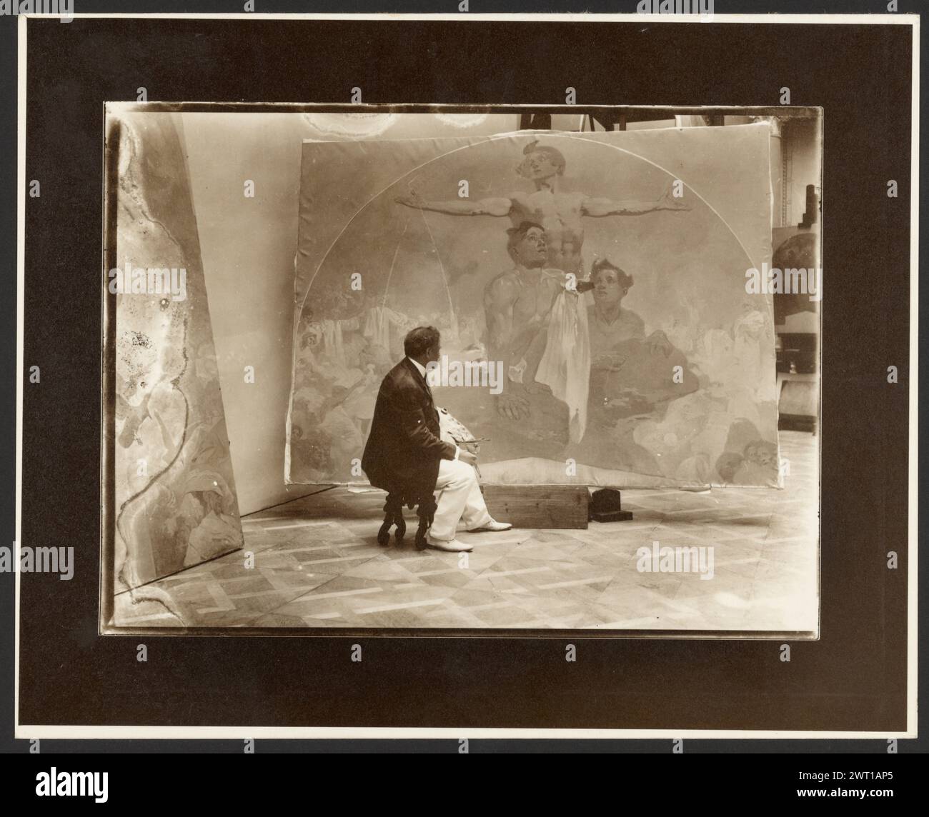 Self-Portrait of Alphonse Mucha at Work on 'Lunette, Through Strength to Liberty, Through Love to Unity!' for the Mayor's Hall Municipal House, Prague. Alphonse Maria Mucha, photographer (Czech, 1860 - 1939) negative 1911, print about 1980 (Verso, sheet) inscribed in pencil, at lower right corner: '60'; in pencil, at upper left corner: '6' [written upside-down] Stock Photo