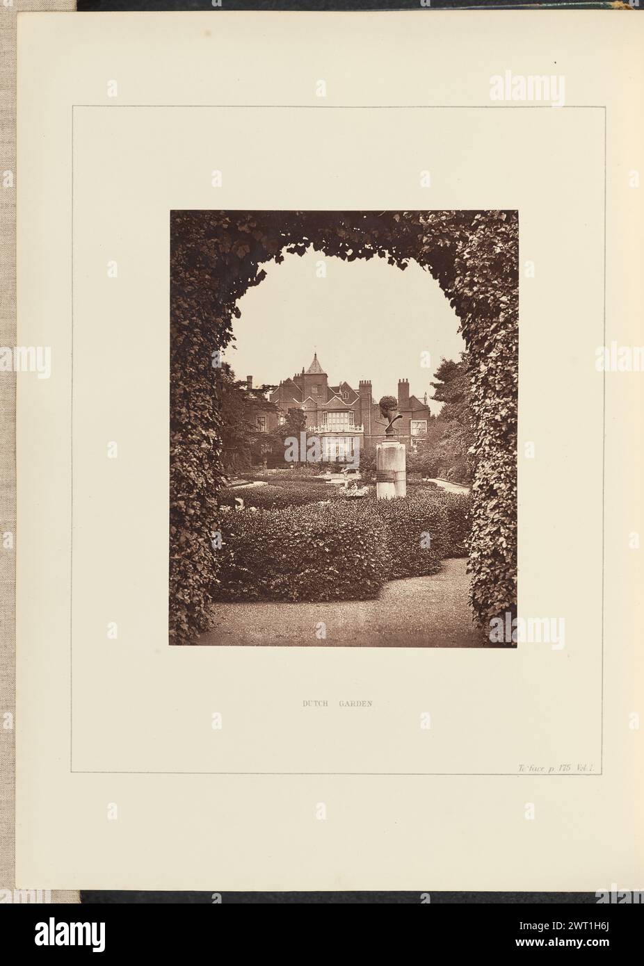 Dutch Garden. Philip H. Delamotte, photographer (British, 1820 - 1889) 1874 View looking into a formal garden from beneath an arched hedge. There is a large bust of a man's head on a pedestal among the manicured hedges. Holland House can be seen in the background. (Recto, mount) lower center, black printed text: 'DUTCH GARDEN.'; lower right, black printed text: 'To face p. 175. Vol. I.'; (Verso, mount) lower left, pencil: 'IB 60.7 (Del)'; Stock Photo