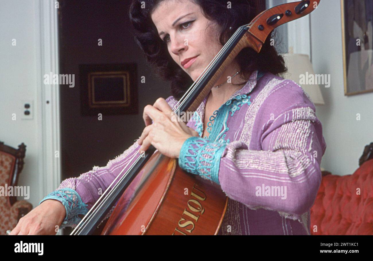 A portrait of the acclaimed cellist Christine Walevska who is best known for her many recordings with Philips Records. Called the 'Goddess of the Cello' she became the first concert musician to perform in Cuba under the Castro regime. This is a late 1970s portrait of her playing in her Manhattan apartment. Stock Photo