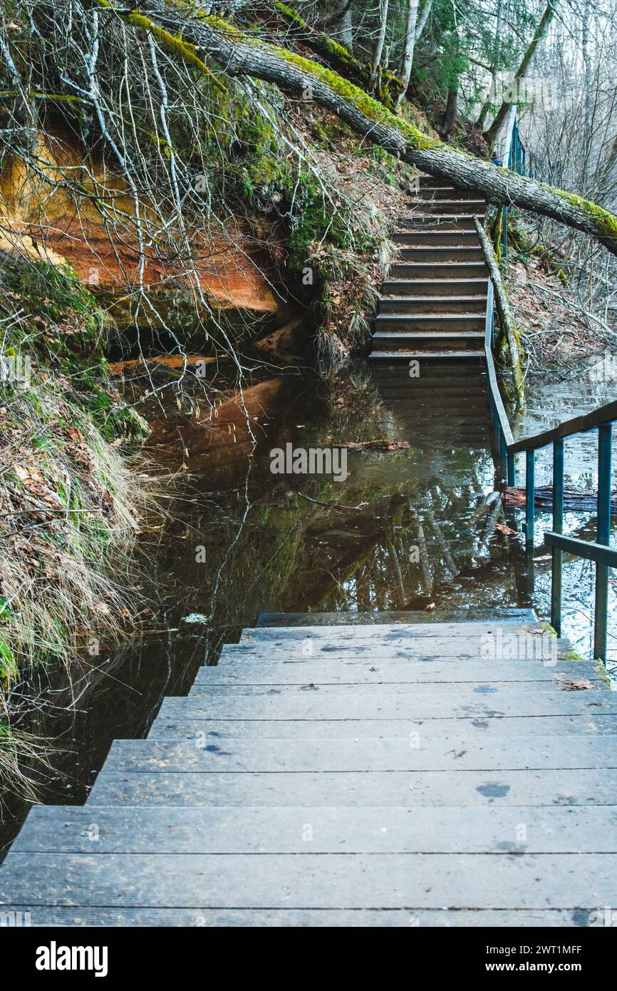 Amidst the red cliffs, a bridge emerges from the waters, a testament to