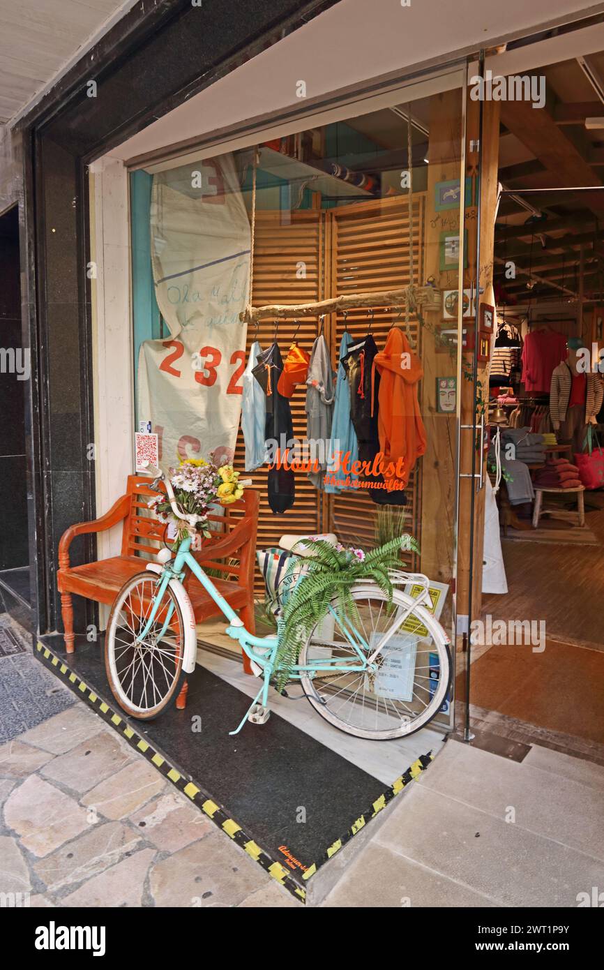 Clothes shop window with bicycle outside Stock Photo
