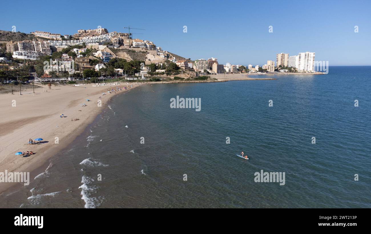 Cullera, Spain - 10 June, 2023: Panoramic view of the Raco beach in Cullera, Valencia, Spain. With people bathing and sunbathing and apartment buildin Stock Photo