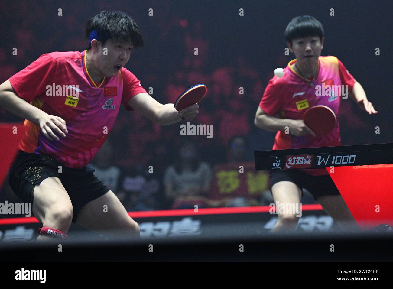 Singapore. 15th Mar, 2024. Sun Yingsha/Wang Chuqin (L) of China compete