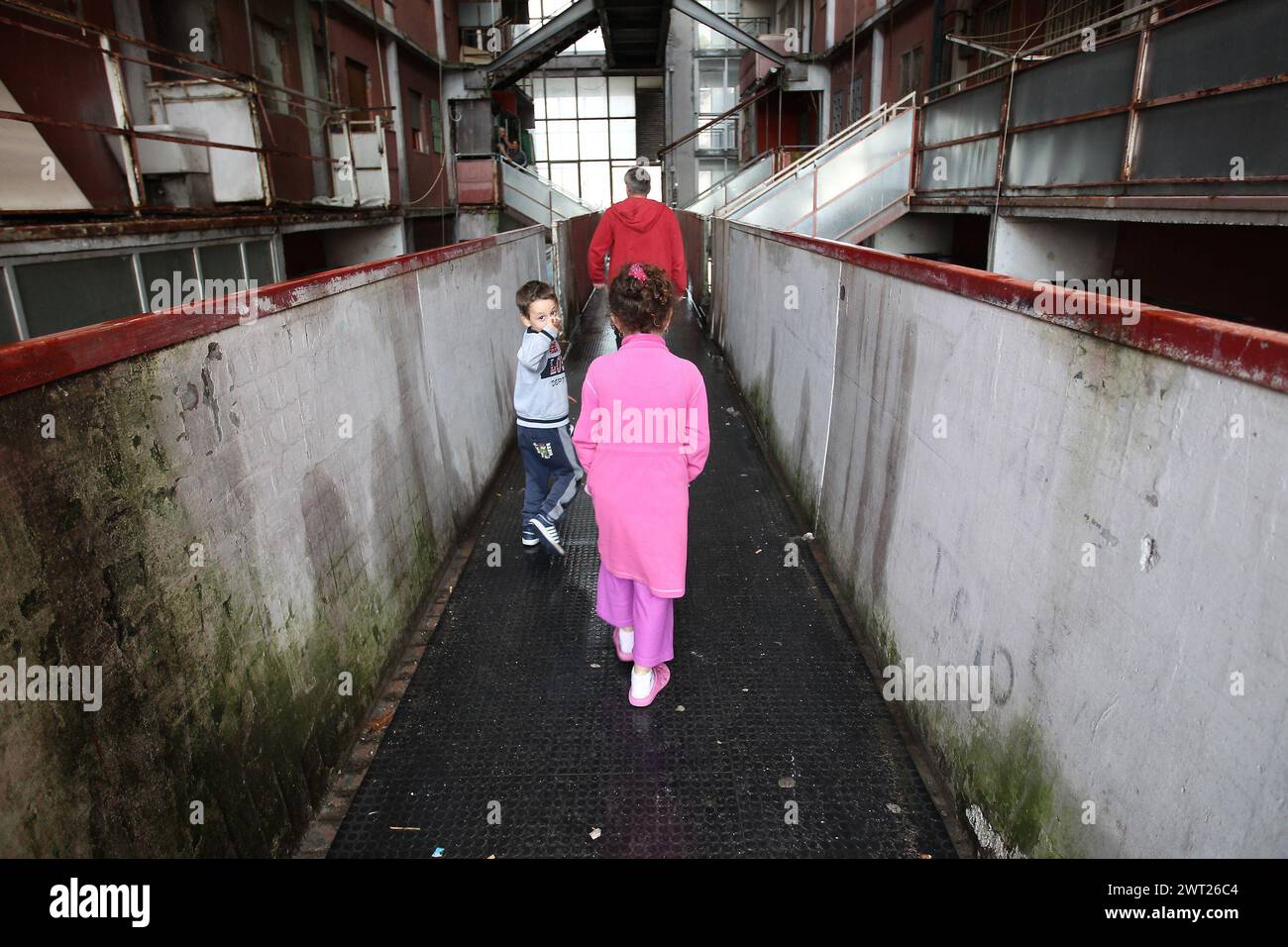 Childs inside a the 'Red Sail' of Scampia. One of the famous buildings in the Scampia district of Naples, where social degradation has reached unsusta Stock Photo