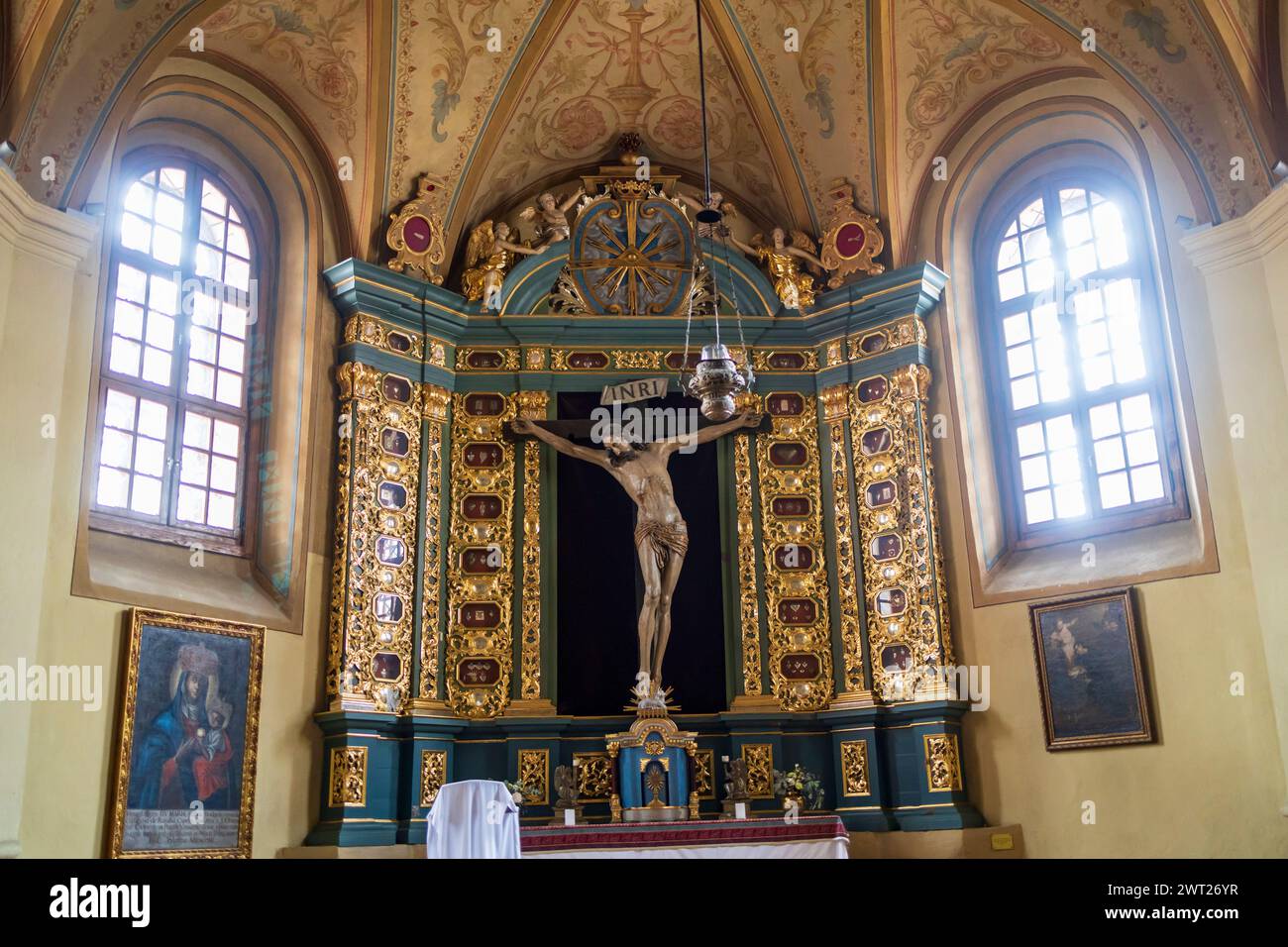 VILNIUS, LITHUANIA - JUNE 15 2023: Interior of the chapel in the Church of St. Francis and St. Bernard with vaulted ceiling and richly decorated Jesus Stock Photo