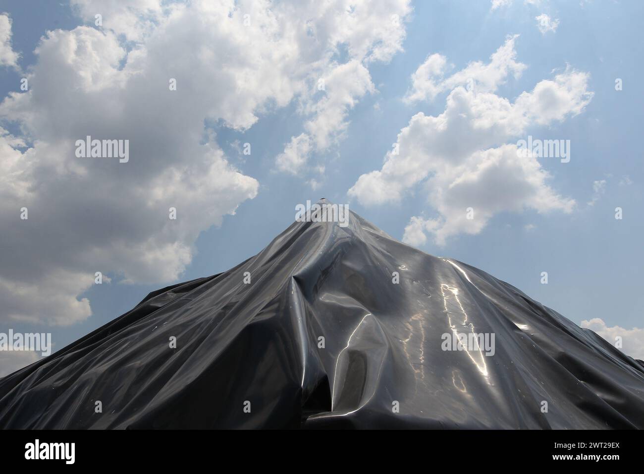 A black plastic canvas covers the garbage bales of San Tammaro, a waste dump in the province of Caserta Stock Photo