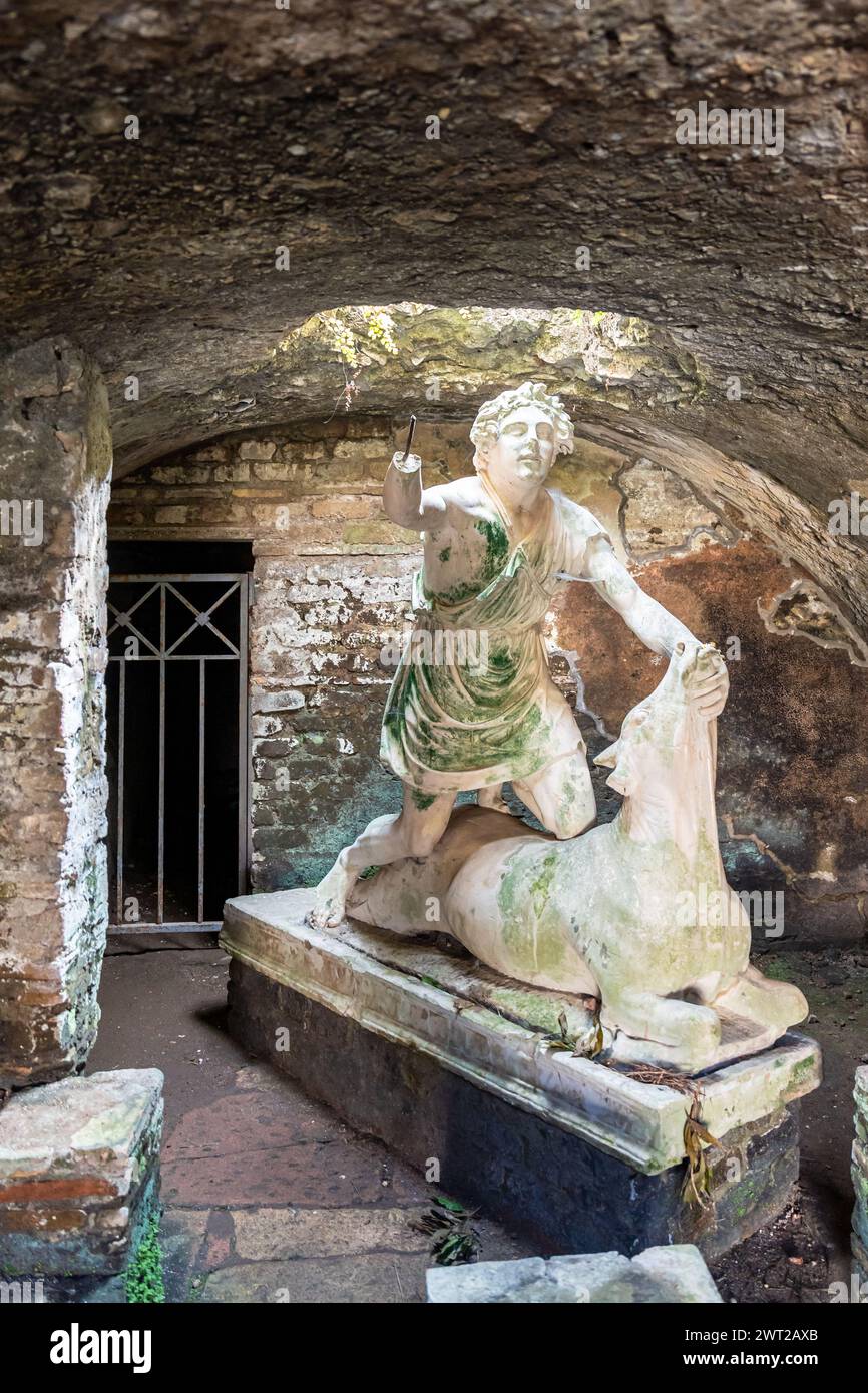 Ruins of ancient roman statue showing a man killing a cow Stock Photo