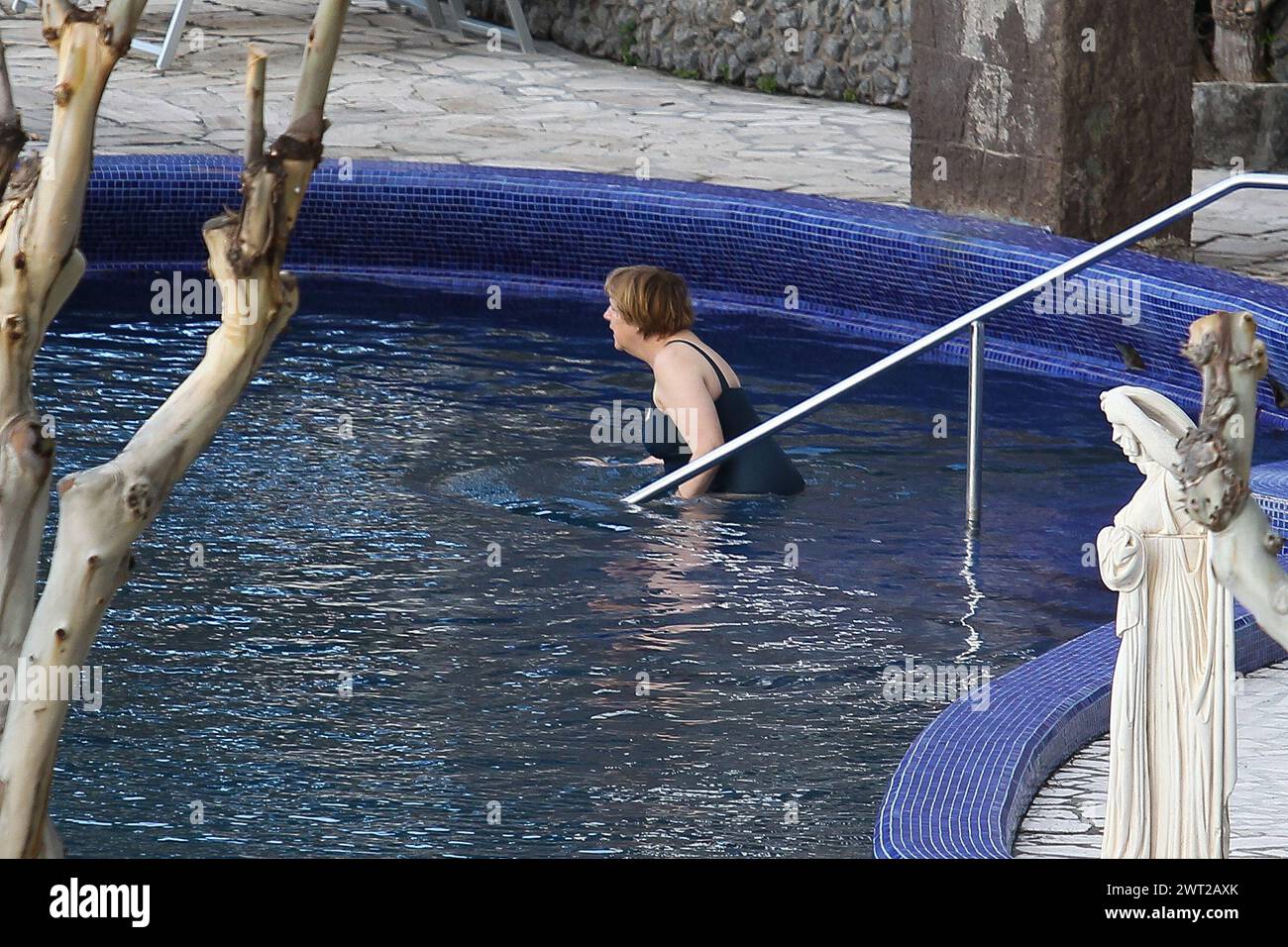 German Chancellor Angela Merkel, enters the spa pool, during the Easter