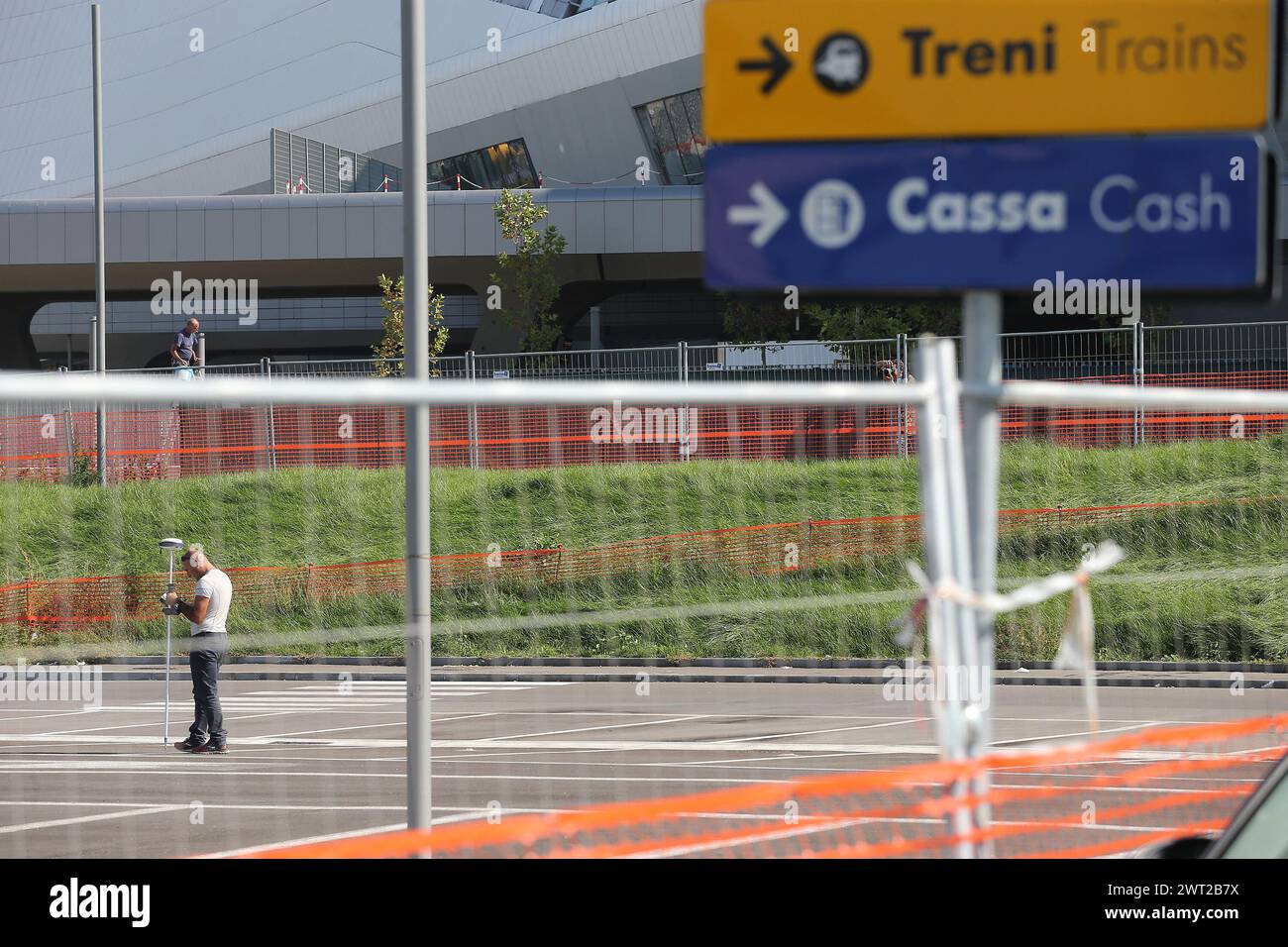 A man with a metal detector in front of the high-speed rail station, TAV, seeks a spot where to start drilling to look for the seizure of toxic waste Stock Photo