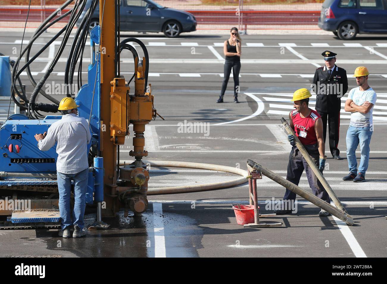 A drill in front of Afragola's high-speed rail station, TAV, and workers while drilling to look for toxic waste burial. On the spot there were also th Stock Photo
