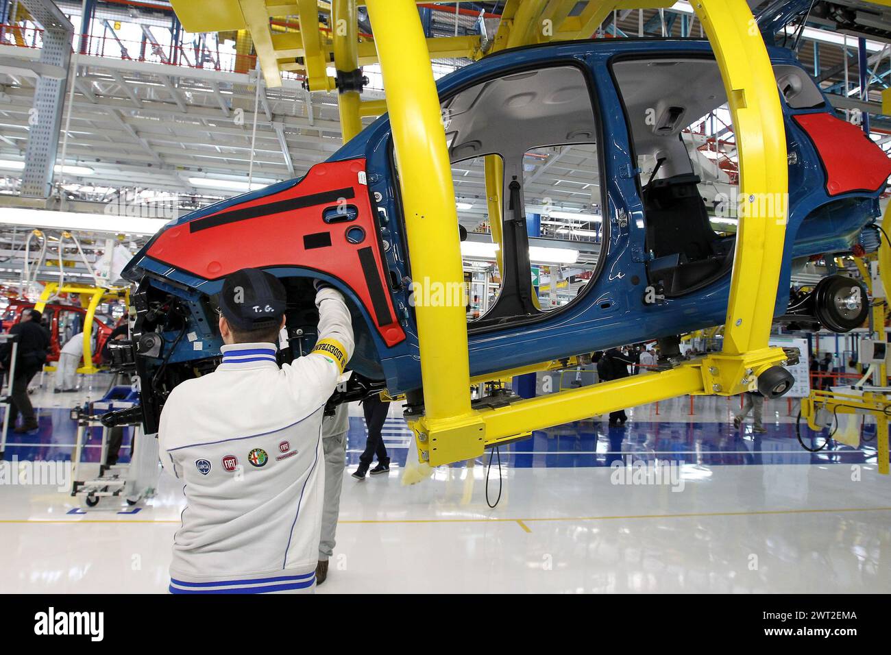 A FIAT worker at the assembly line of the Pomigliano D'Arco car factory. Stock Photo