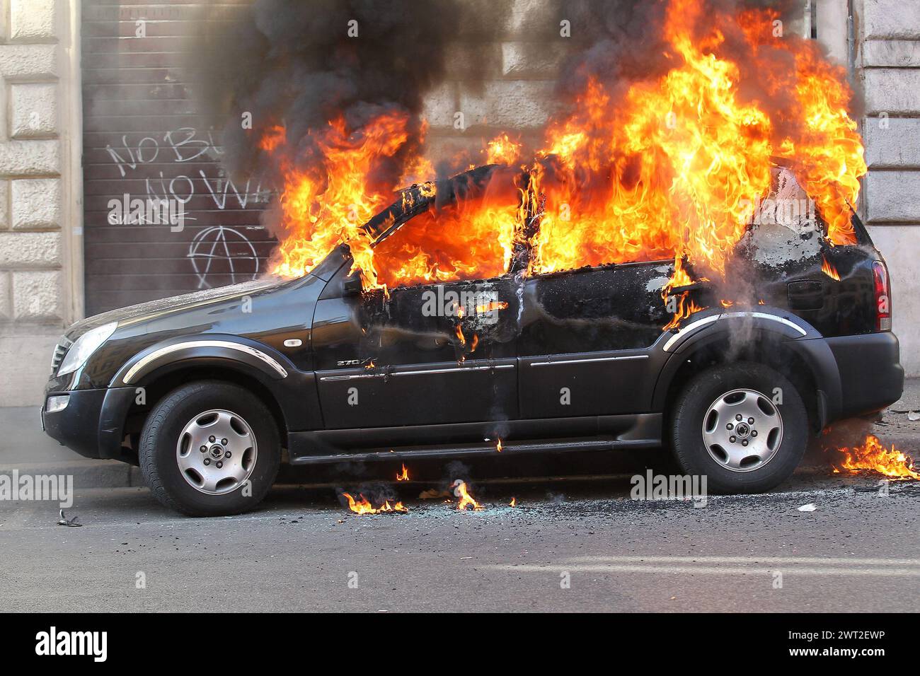A car burned by the Black Bloc during an event in Rome Stock Photo