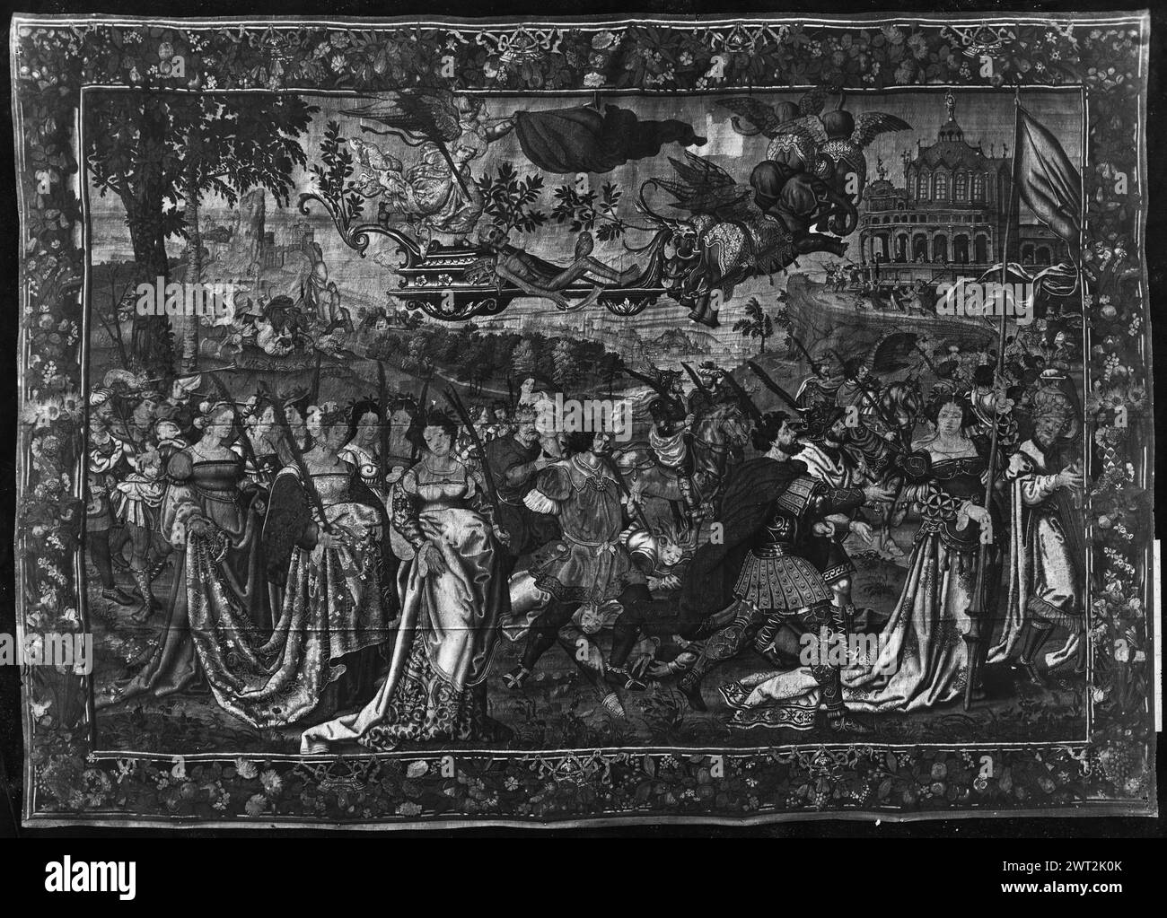 Triumph of Fame (over Death). Crétif, Marc (Netherlandish (before 1600) - Flanders, act.1550-1600) (workshop) [weaver] c. 1540 Tapestry Dimensions: H 420 X W 597 cm Tapestry Materials/Techniques: wool & silk Culture: Flemish Weaving Center: Brussels Ownership History: Inventory of Carlos III (1788). Inventory of Fernando VII (1834). Inventory of 'Las Tapicerías de la Corona' (1880). Spain, Segovia, Segovia, Palacio de San Ildefonso, accno. A. 264-7794. Winged figure of Fame sounds trumpet over figure of Death as skeleton who lies in chariot in sky driven by flying elephants (center, top), proc Stock Photo