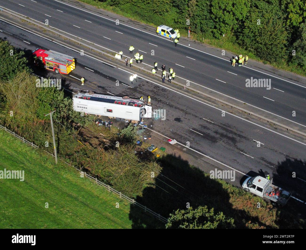 File photo dated 29/9/2023 of emergency services at the scene of a coach crash on the M53 motorway, between junction 5 at Ellesmere Port and junction 4 at Bebbington. The driver of a school bus which crashed on a motorway died from natural causes, a coroner's office has said. Stephen Shrimpton, 40, died when the coach he was driving crashed on the northbound M53 in Wirral, Merseyside, on September 29 last year as he was taking children to West Kirby and Calday Grange grammar schools. Jessica Baker, 15, one of about 50 students onboard, was killed in the crash just after 8am. Issue date: Friday Stock Photo
