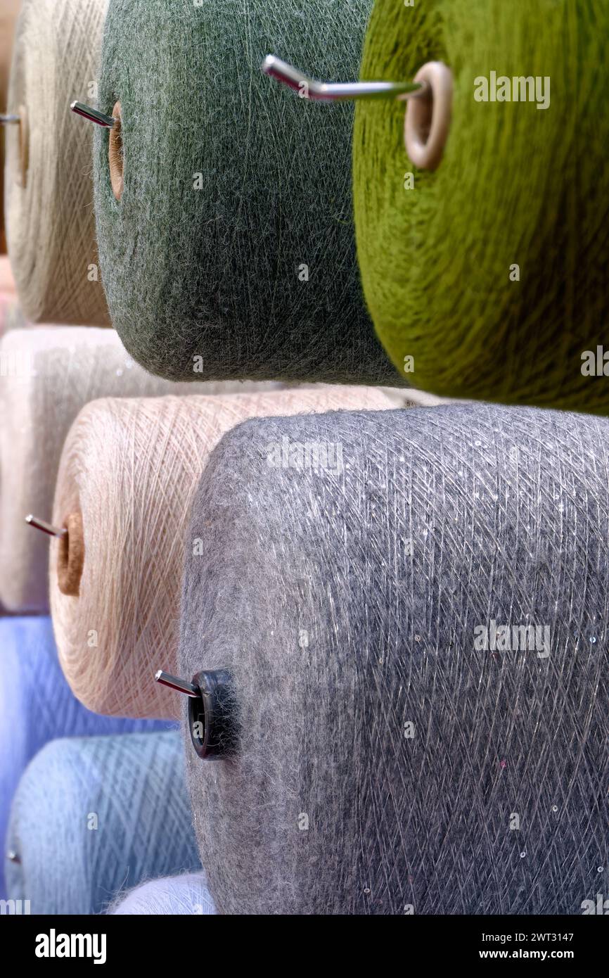 Assorted spools of multi-colored wool threads, abstract textile ...