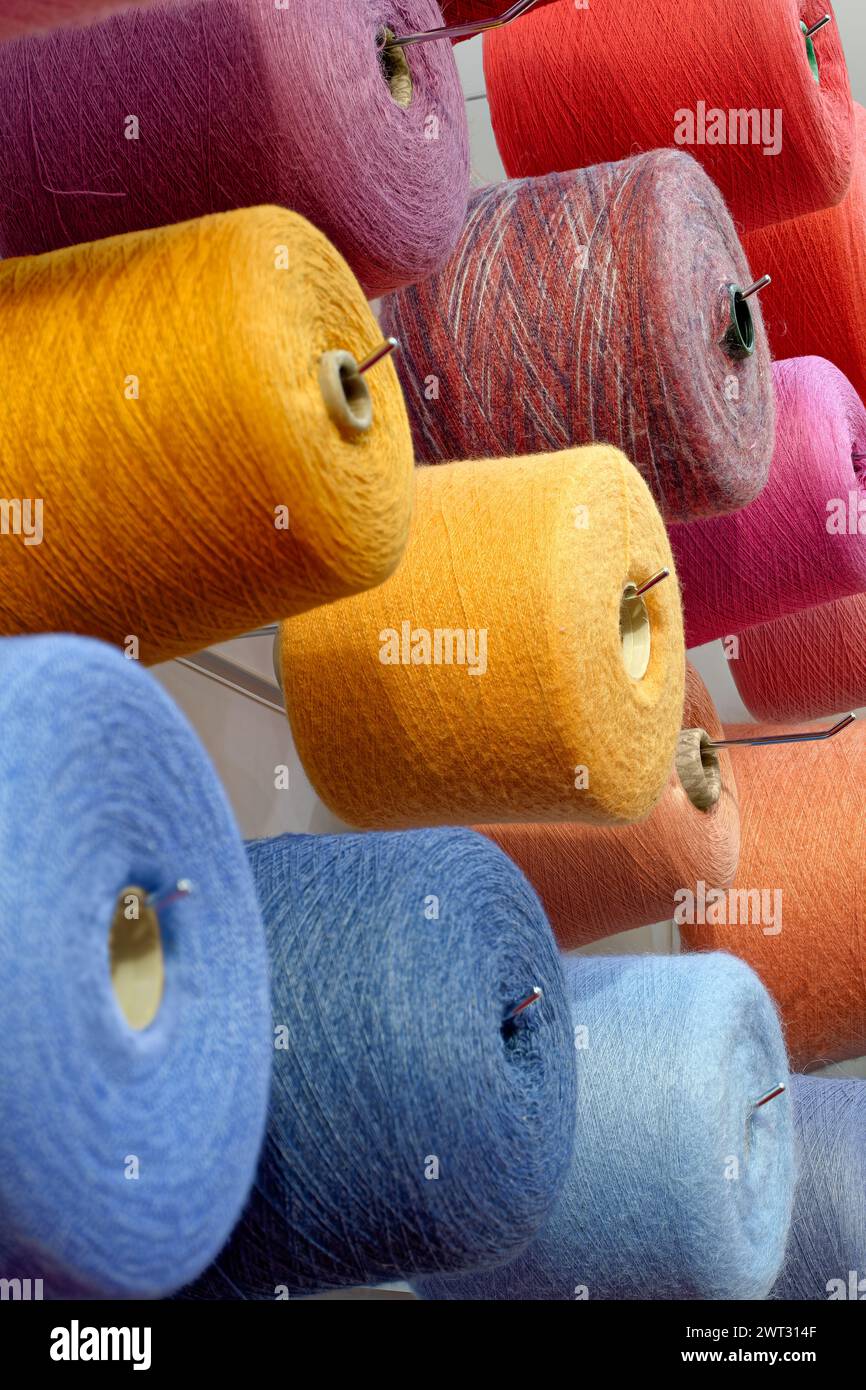 Assorted spools of multi-colored wool threads, abstract textile ...