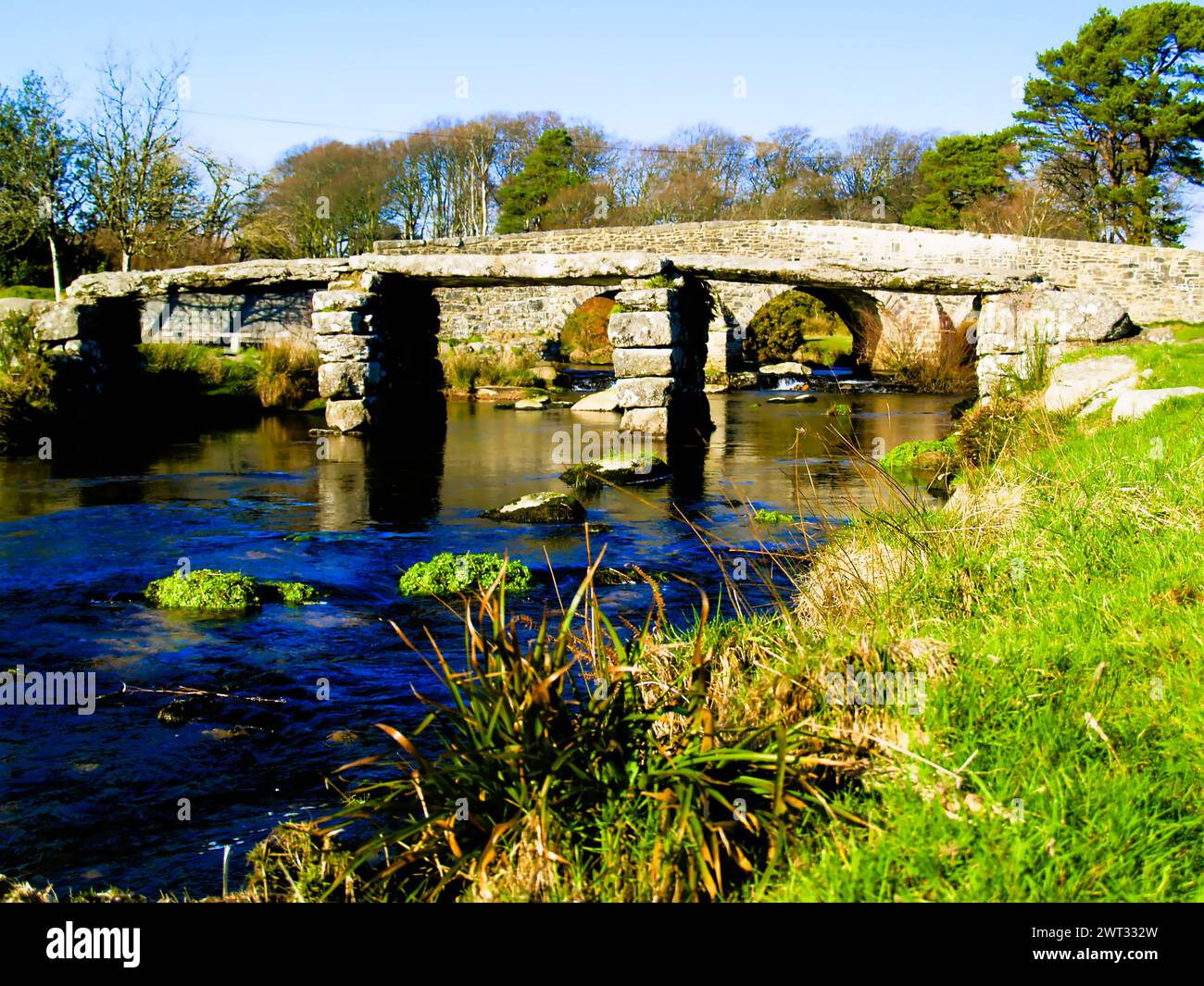 The 13th century Clapper bridge and the road bridge built in the 1780's over the East Dart river at Postbridge on the route between Princetown and Mor Stock Photo