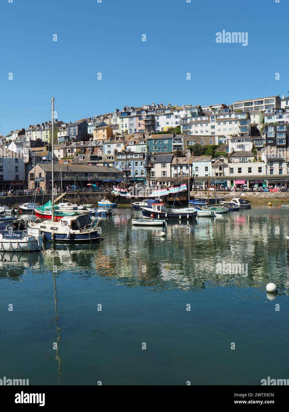 A replica of the Golden Hind sailing ship alongside the quayside in Brixham harbour, Torbay, South Devon, Southwest England. Stock Photo