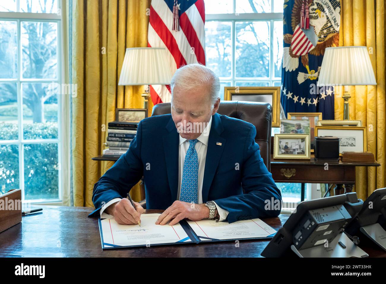Washington, United States of America. 01 March, 2024. U.S President Joe Biden signs the Congressional continuing resolution for short-term funding to avoid a partial government shutdown in the Oval Office of the White House, March 1, 2024 in Washington, D.C.   Credit: Cameron Smith/White House Photo/Alamy Live News Stock Photo