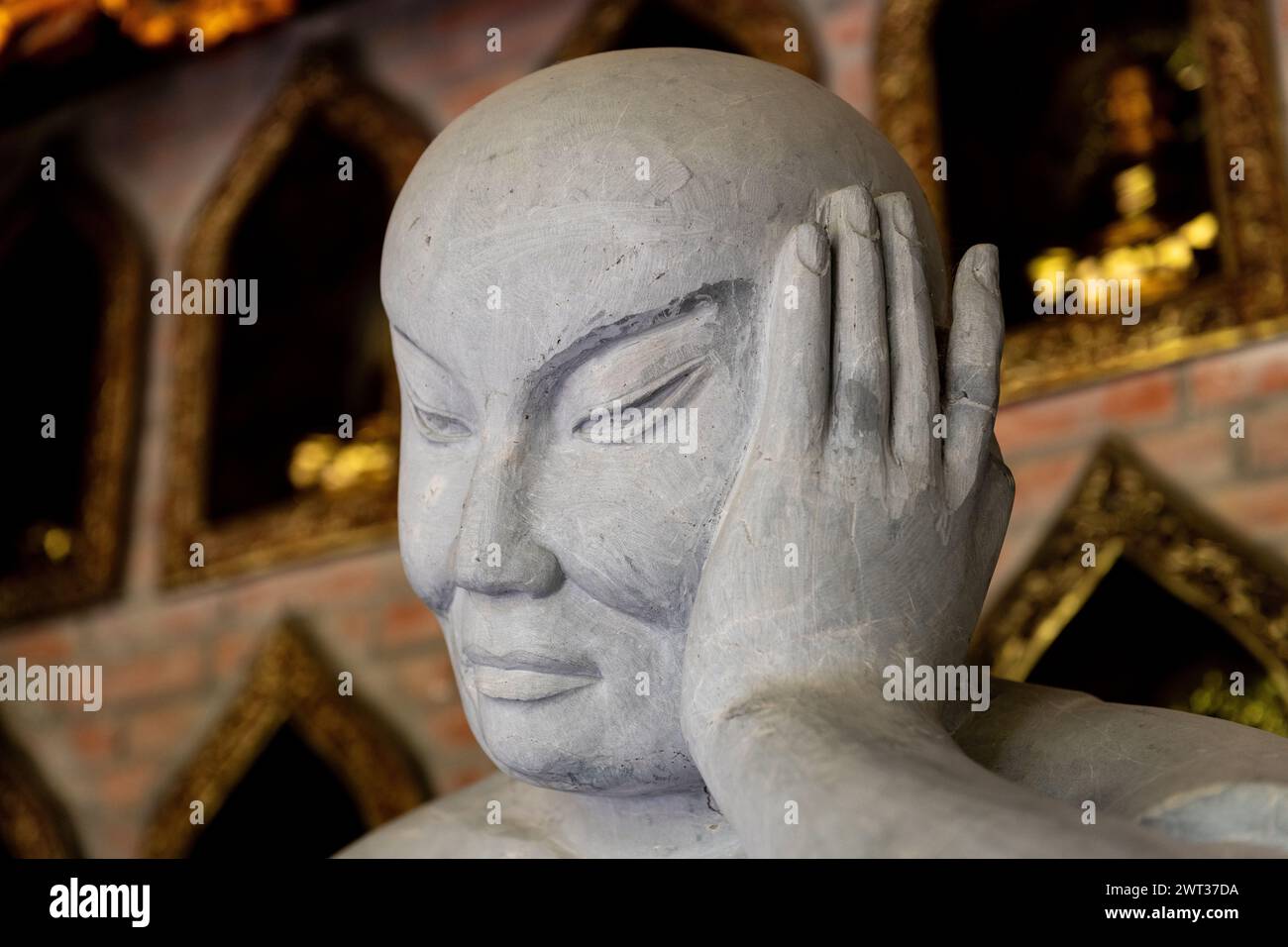 Closeup of the hand and head of one of many stone, Buddhist statues in the Bai Dinh temple pagoda complex in Ninh Binh, northern Vietnam. Stock Photo