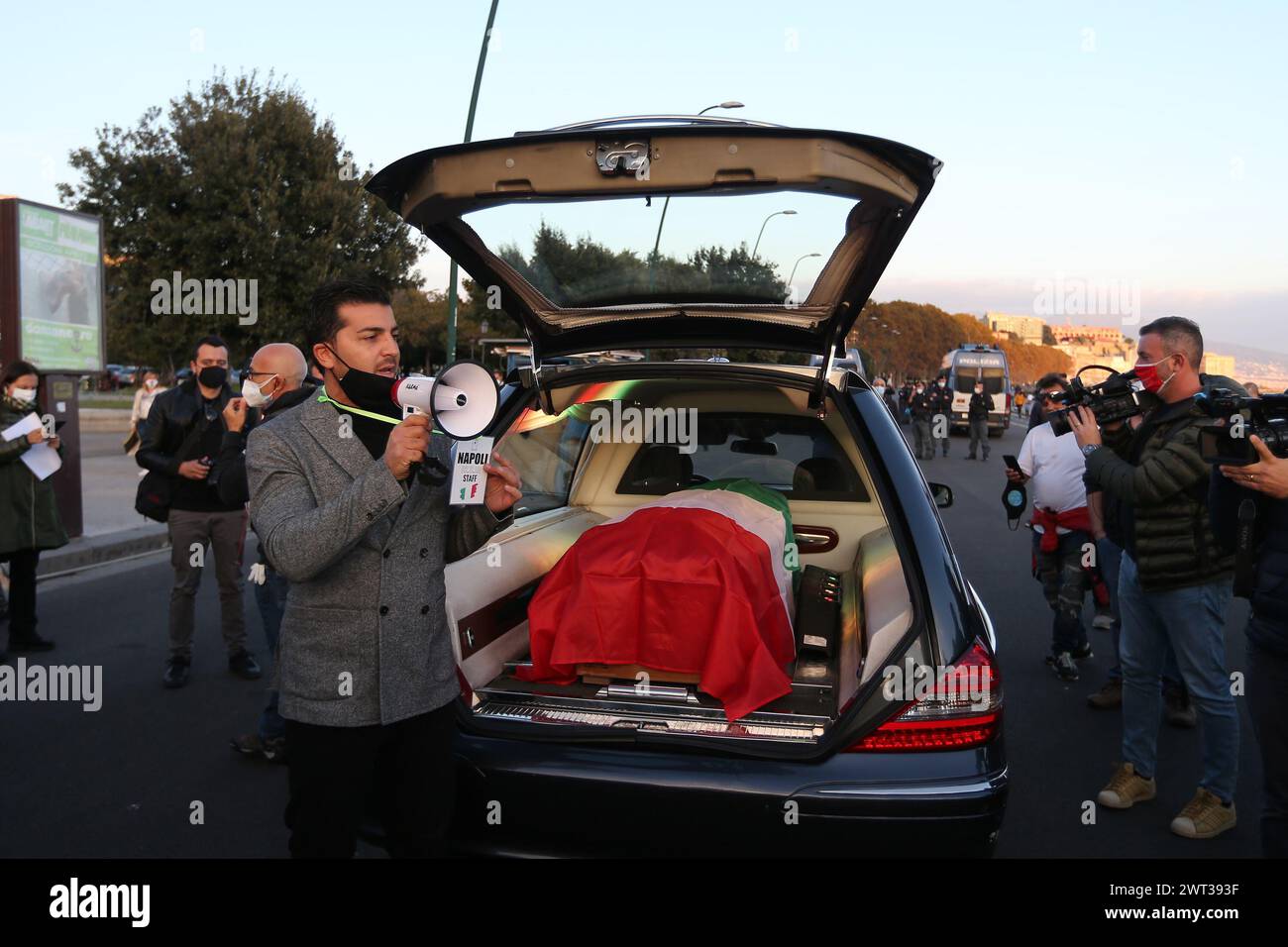 A man with a megaphone near a coffin during the protest Funeral of the Campania Economy, against the partial lockdown measures of the Italian and Regi Stock Photo