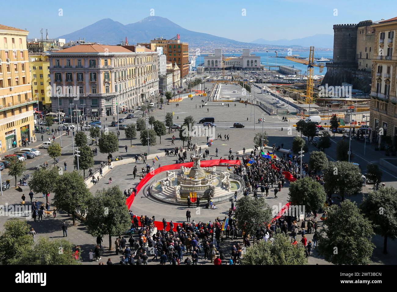 People with a giant red flag, in Municipio square, symbolizing the blood shed in war,  in front of the Town Hall of Naples, during the demonstration f Stock Photo