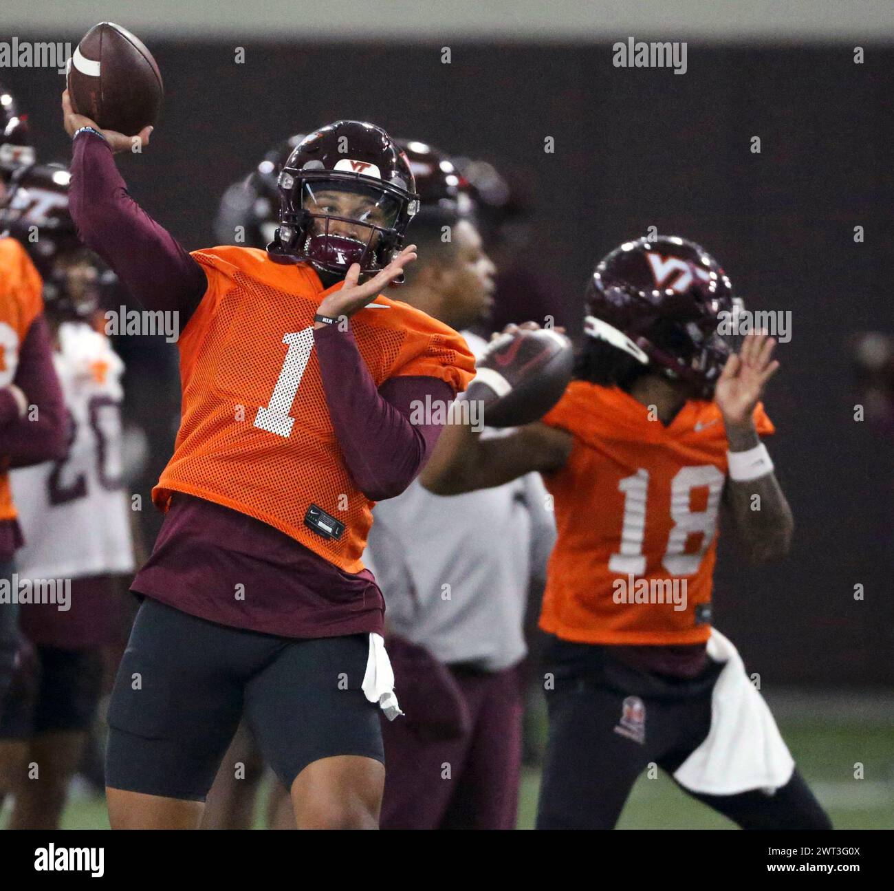 Virginia Tech quarterbacks Kyron Drones (1) and William "Pop" Watson III (18) throw during NCAA