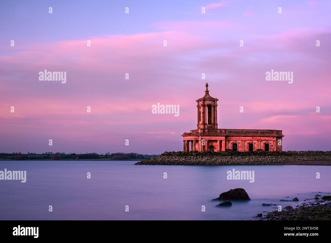 Normanton Church Rutland water at sunset - the ideal wedding photography and ceremony location - with late sun lit clouds and sky and smooth water Stock Photo
