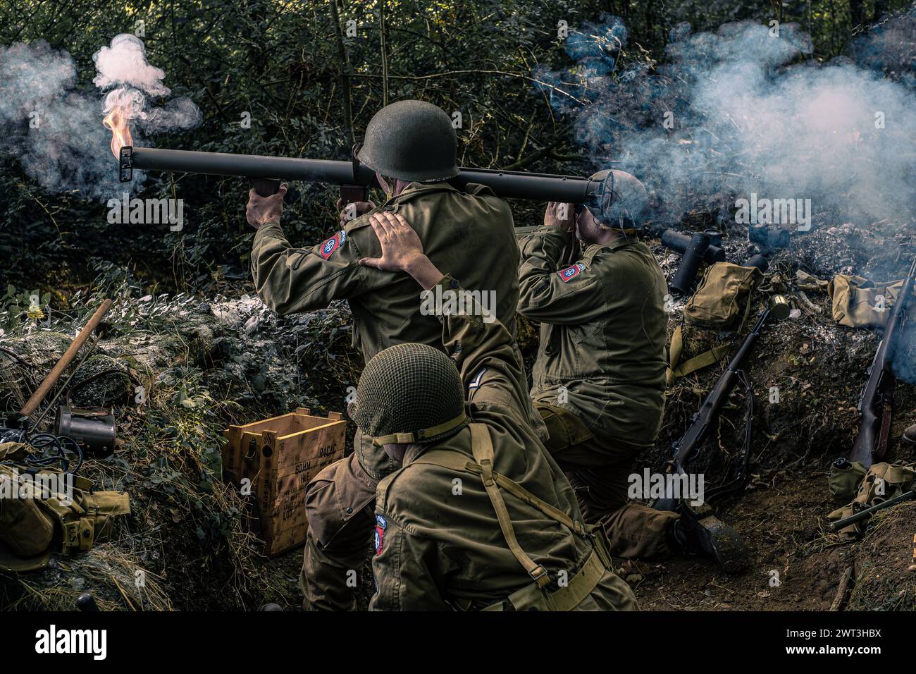 World war 2 US soldier reenactors firing a bazooka with flame and smoke Stock Photo