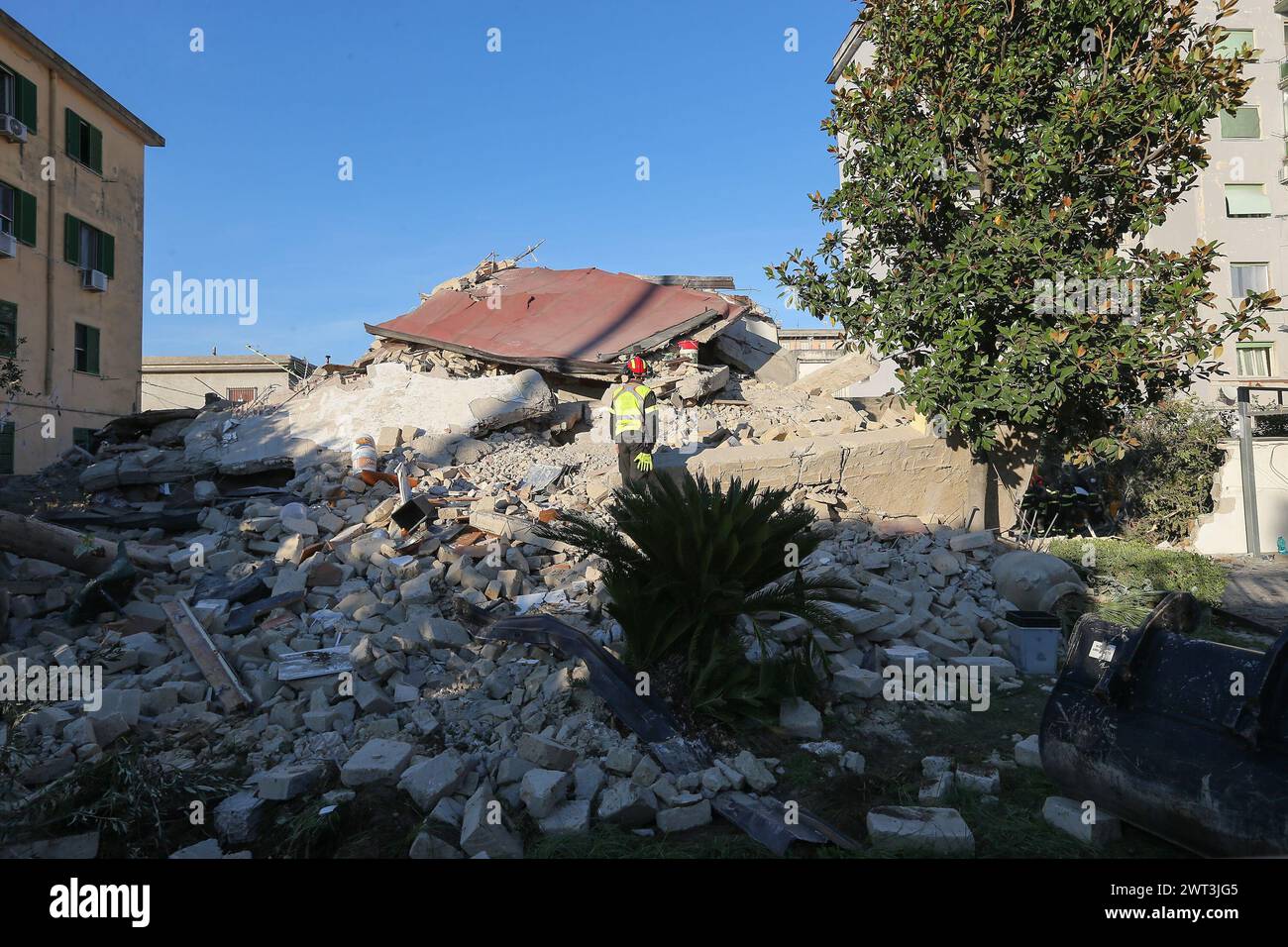 A firefighter walked on the rubble of the completely collapsed building in San Felice Cancello, in the province of Caserta, following an explosion due Stock Photo