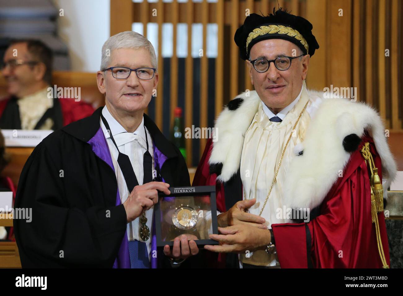 The CEO of Apple, Tim Cook, receives from the rector Matteo Lorito (on right), the honorary degree by the Federico II University of Naples. Stock Photo