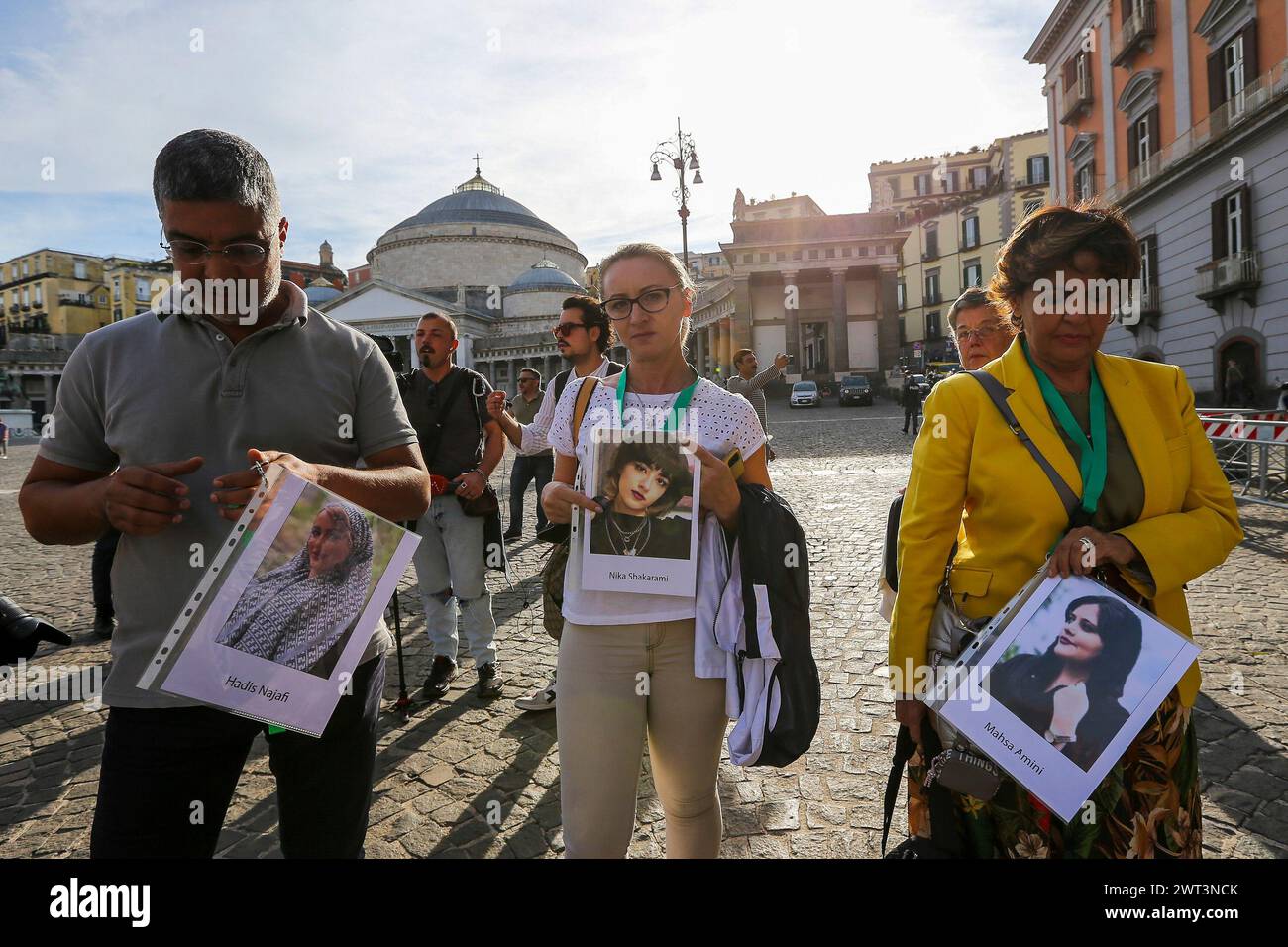 People with photographs of Iranian women, during the demonstration in ...