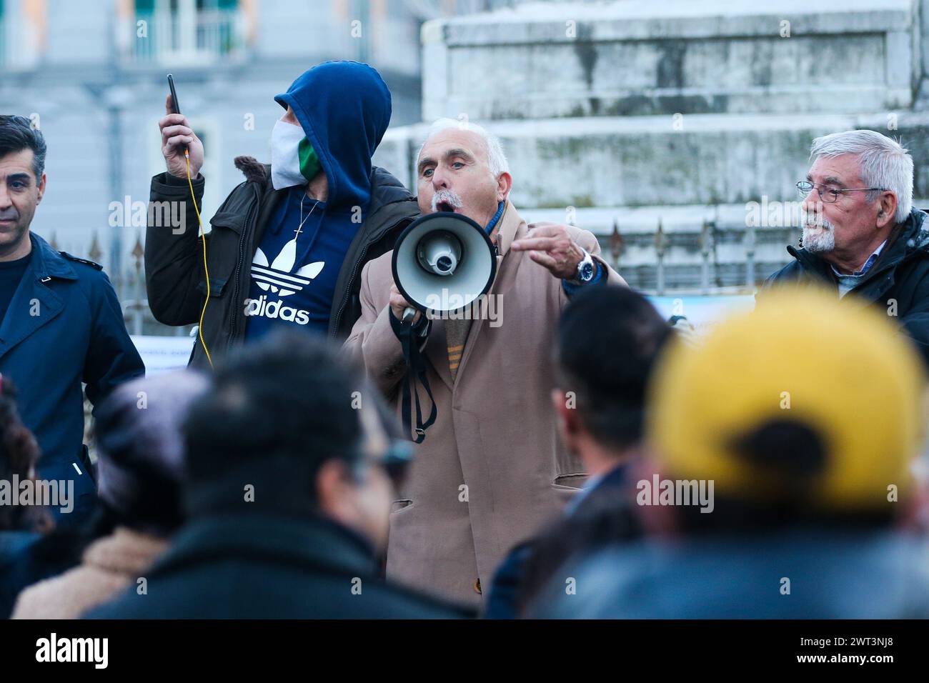 Former general Antonio Pappalardo, leader of the orange vests, speaks with a megaphone during the No Green Pass and No Vax demonstration in Naples. Stock Photo