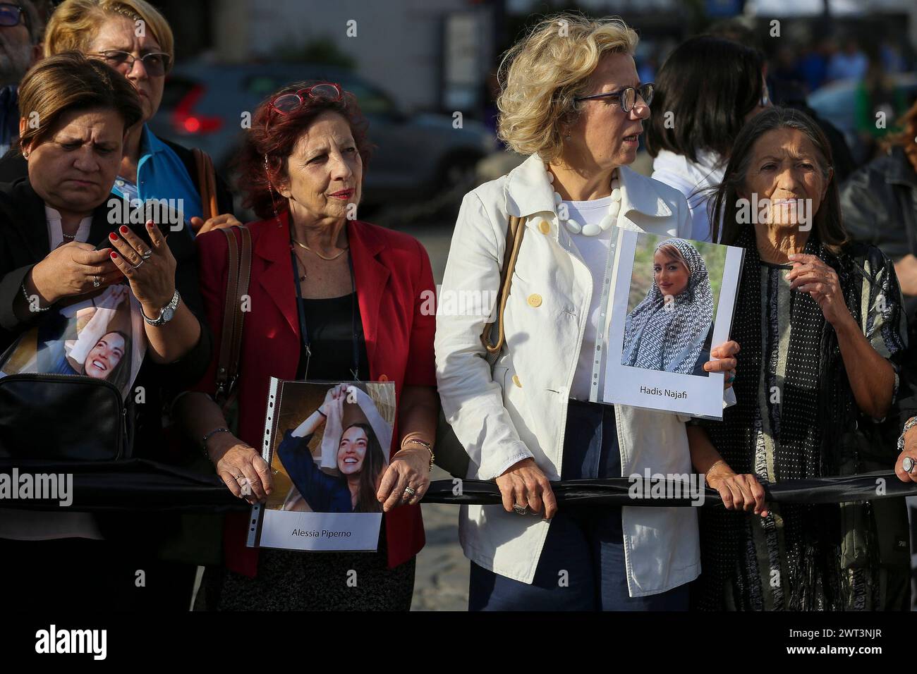 People with photographs of Iranian woman and an Italian woman detained ...