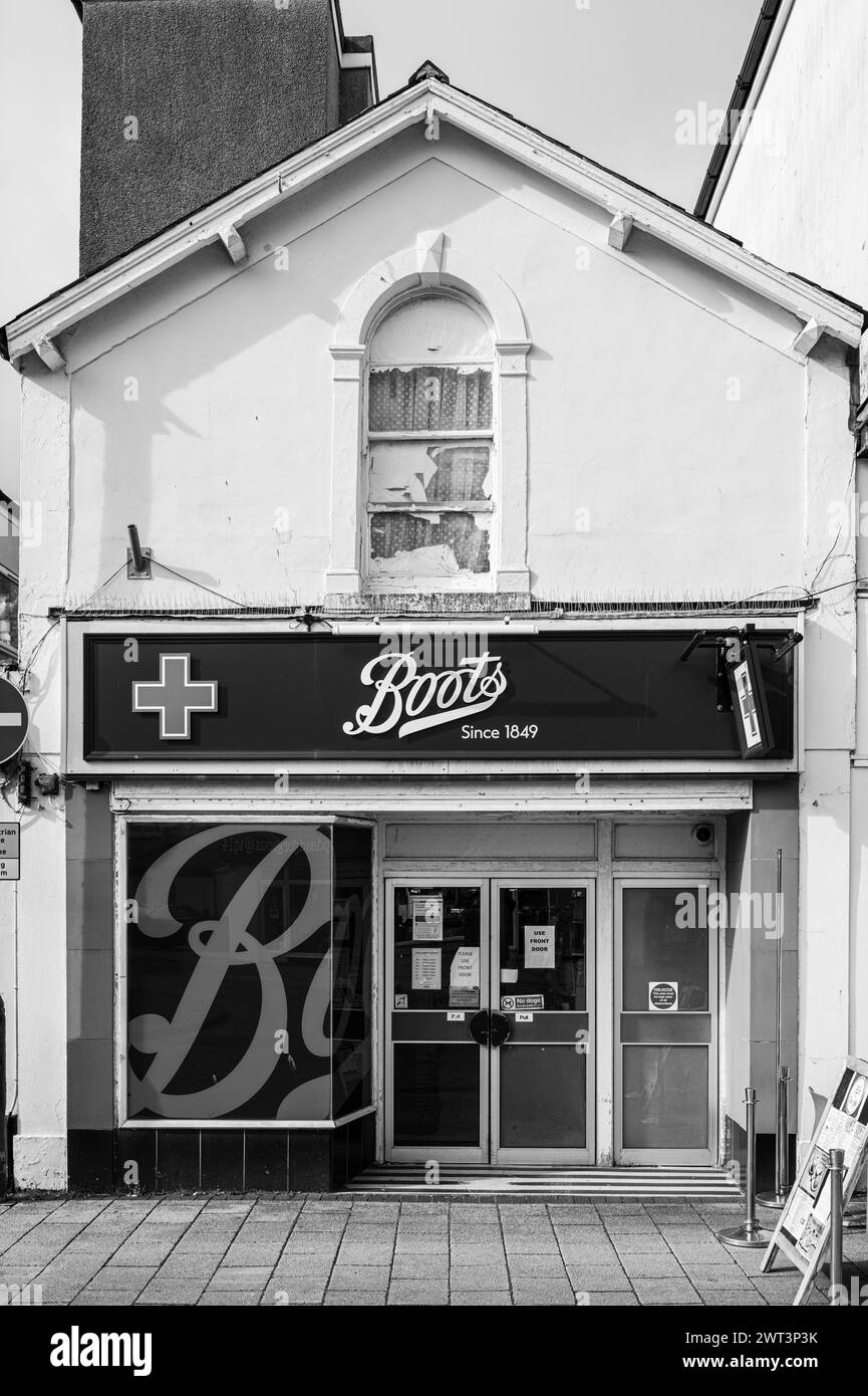 Rear entrance that is not in use of Boots pharmacy in Teignmouth, Devon, UK. Black & white photograph. Stock Photo