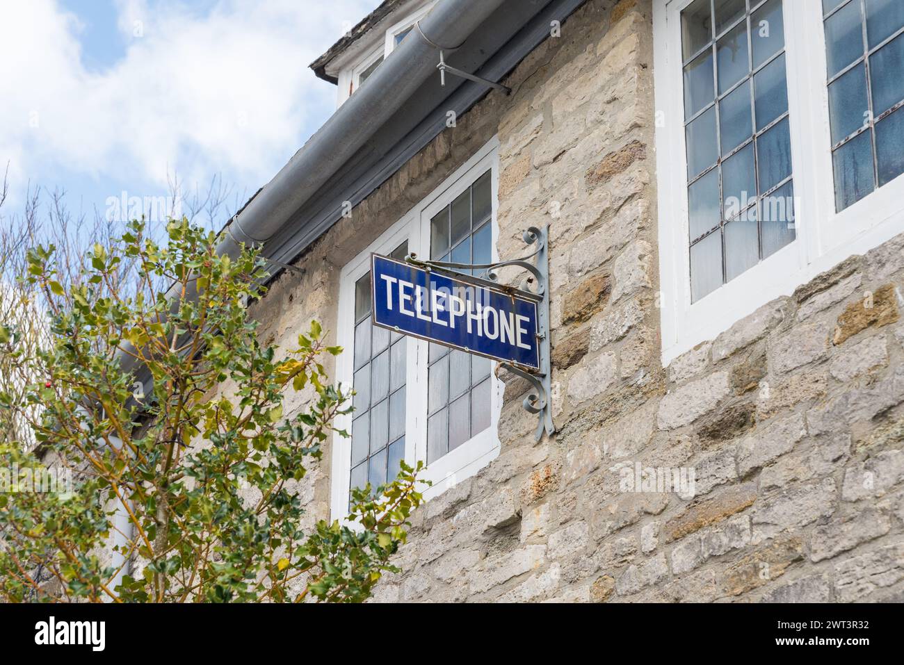 Old fashioned vintage public telephone sign in the village of Corfe ...