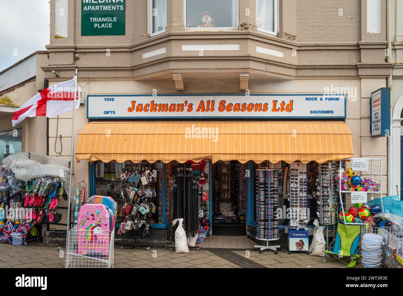 Jackman's All seasons Ltd  front entrance of the gift shop in Teignmouth, Devon, England, UK. Articles for sale in racks and stacked on the pavement. Stock Photo