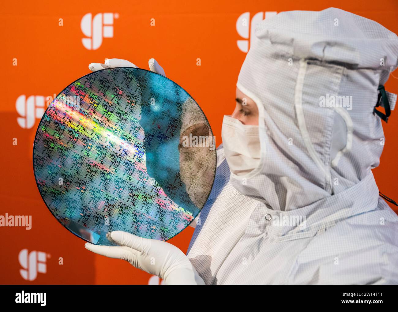Drazdany, Germany. 15th Mar, 2024. Czech President Petr Pavel, not seen, visited the GlobalFoundries microchip factory in Saxony, on March 15, 2024, in Dresden, Germany. Pictured, a girl shows the semiconductors produced on a silicon wafer. Credit: Ondrej Hajek/CTK Photo/Alamy Live News Stock Photo