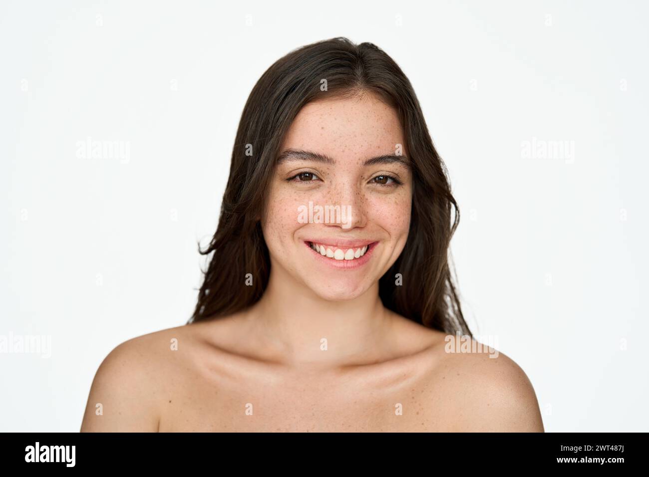 Happy pretty brunette girl with freckles face, beauty portrait isolated on white. Stock Photo